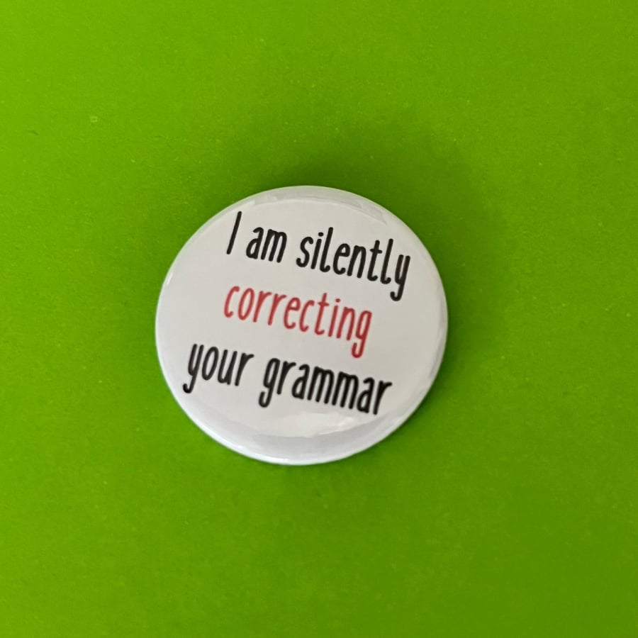 I am silently correcting your grammar. Pin badge, pocket pebble or magnet. Teach