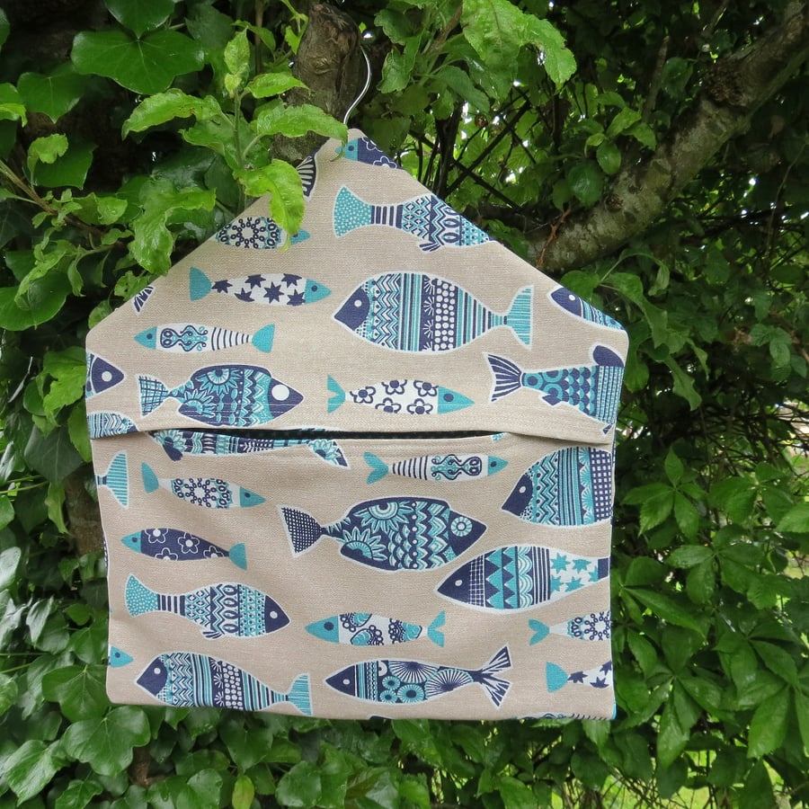 A peg bag with a Scandi fish design.  Peg storage.