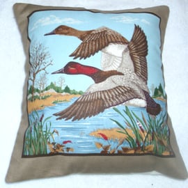Two ducks flying in to land on a river with trees in the distance 10" cushion