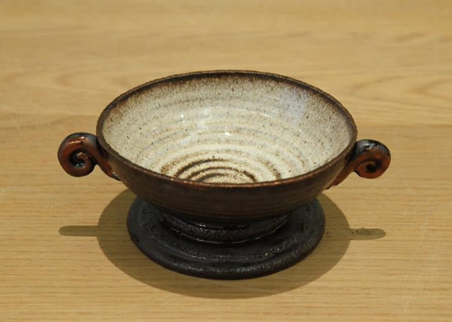 Small unique one off wheel thrown black clay bowl.