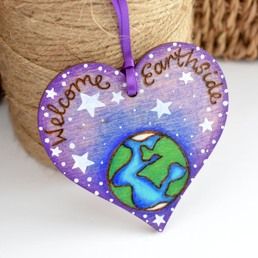 Welcome Earthside. New baby pyrography hanging heart decoration with colour. 