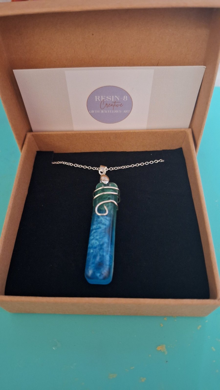 Blue resin wire wrapped silver pendant