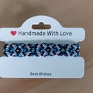 Handwoven Friendship Bracelet in Black, Blue & Pink – Geometric Diamond Pattern