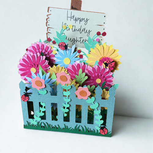 Garden with a fence, greeting noticeboard and ladybird card