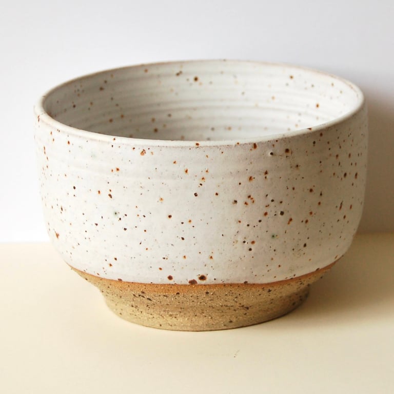 Handmade modern bowl in flecked clay with matt white speckled glaze.