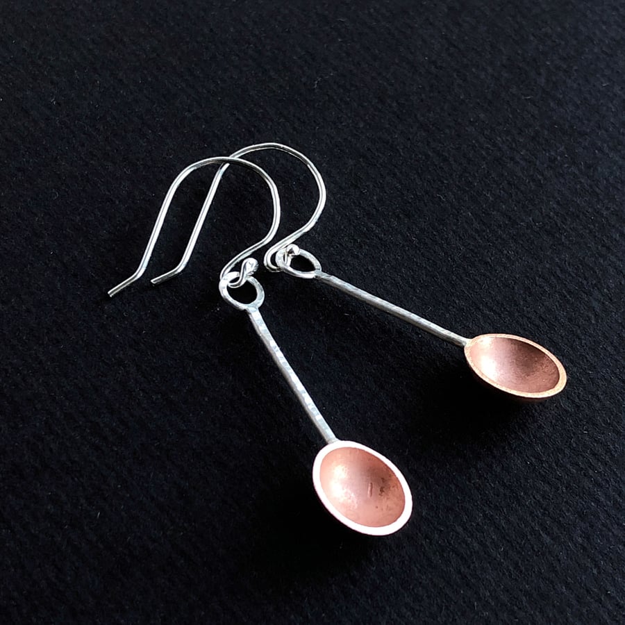 Sterling silver and copper dangle earrings with hammered detail.