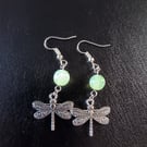 Silver dragonfly charm dangle earrings with green bead detail