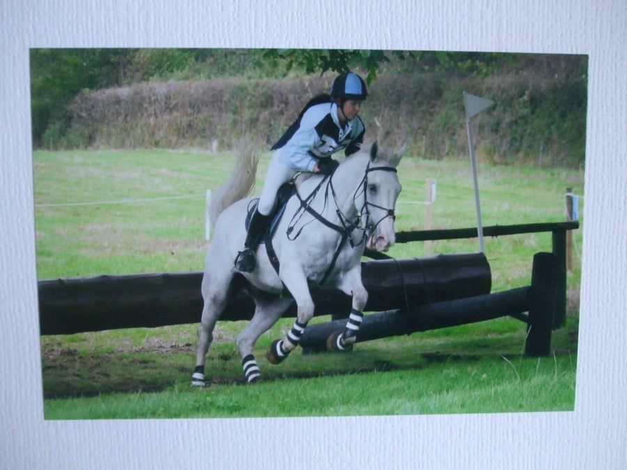 Photographic greetings card of a white horse and rider.