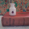 Miniature stoneware bud vase with ladybird decoration
