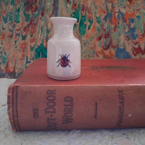 Miniature stoneware bud vase with ladybird decoration