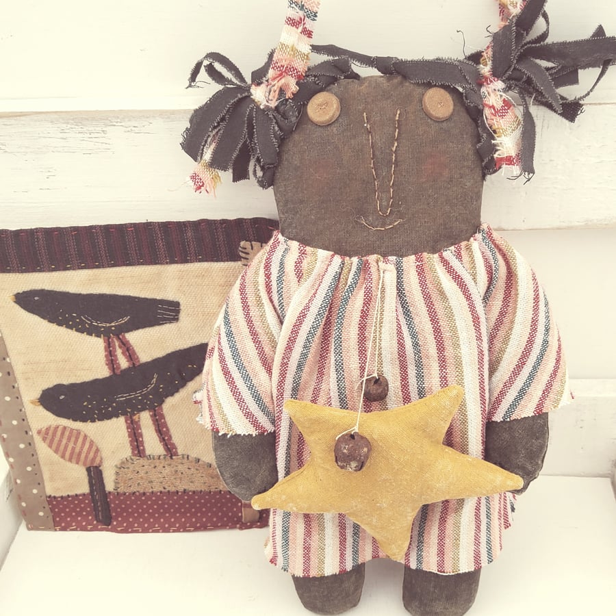 Primitive black American doll with star