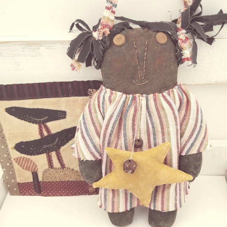 Primitive black American doll with star