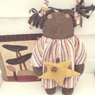 Primitive black American doll with star