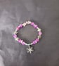 Elasticated beaded winter bracelet with crystal chip and silver snowflake charm  - Image 1