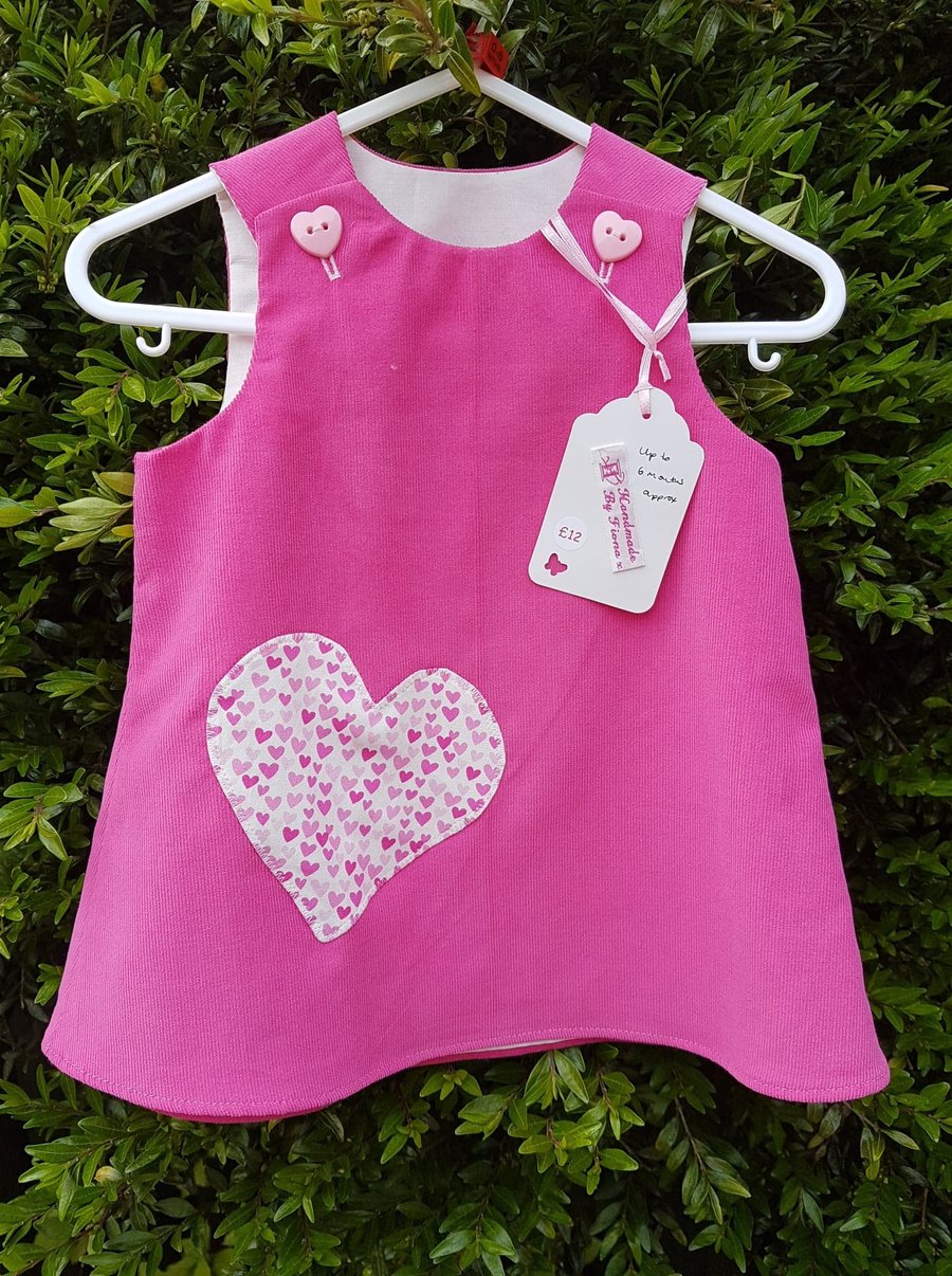 Age: 3-6m. Rose pink baby needlecord pinafore dress. 