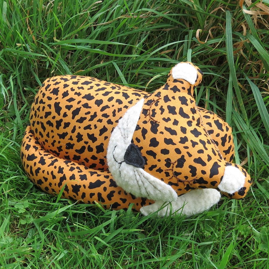 A snoozy cheetah cushion.   32cm in length.   Jungle decor.