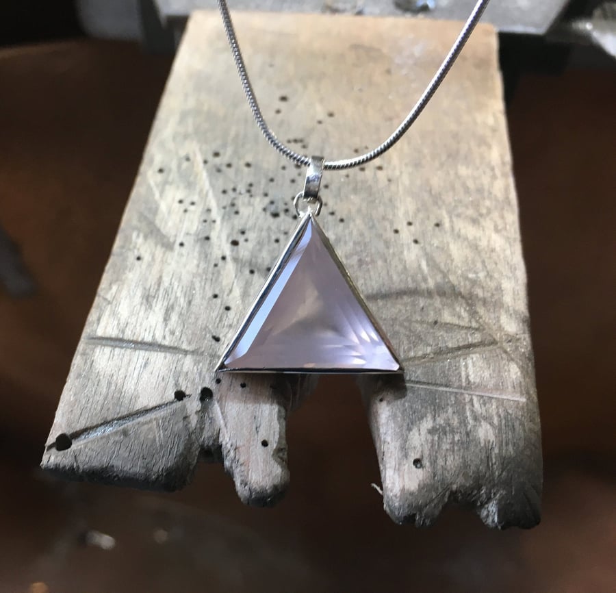 Triangular Rose Quartz in a silver setting, double sided to show amazing facets 
