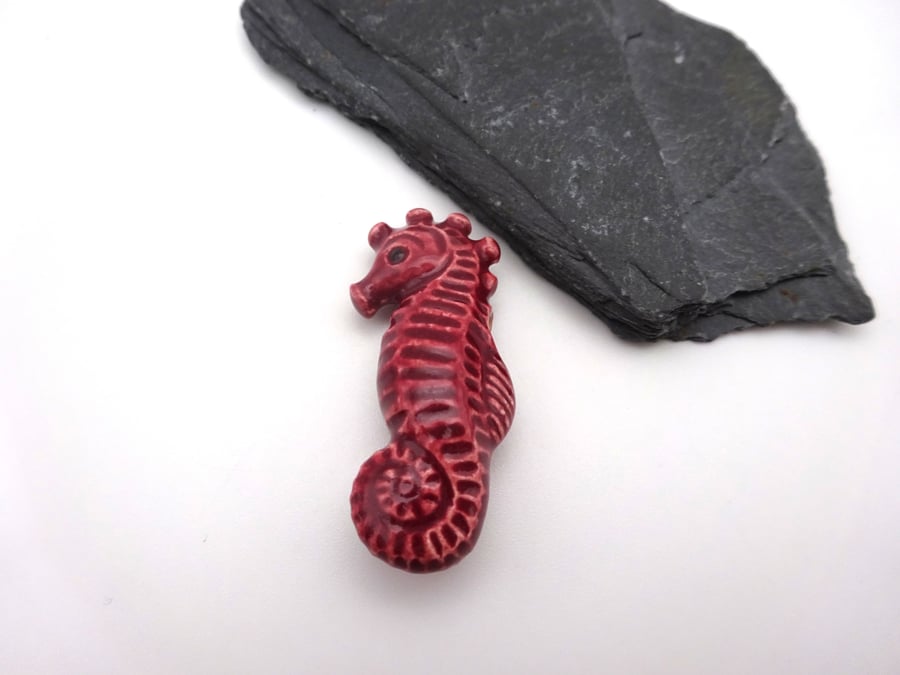 red ceramic seahorse pendant