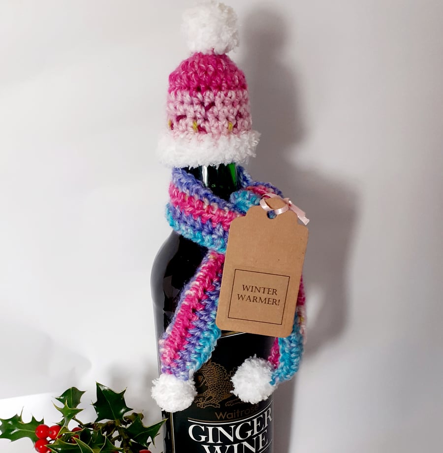 Crochet Hat and Scarf Bottle Decoration . Pinks and blues.