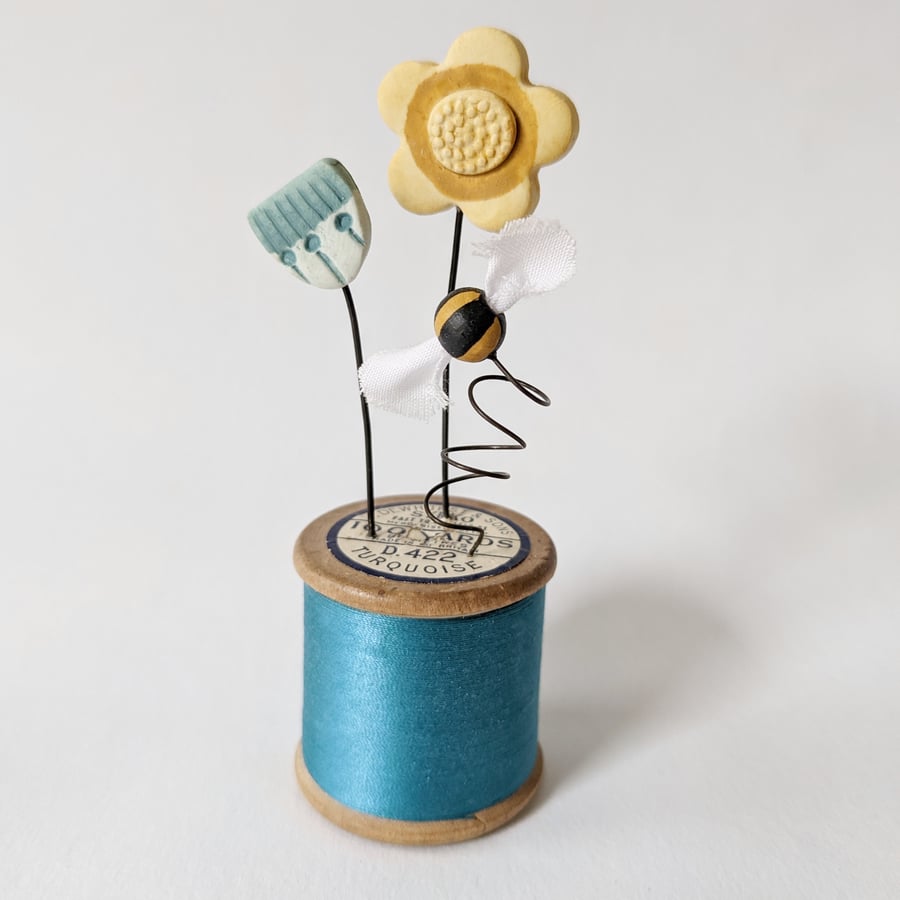 Clay Flowers and Bee on a Vintage Bobbin