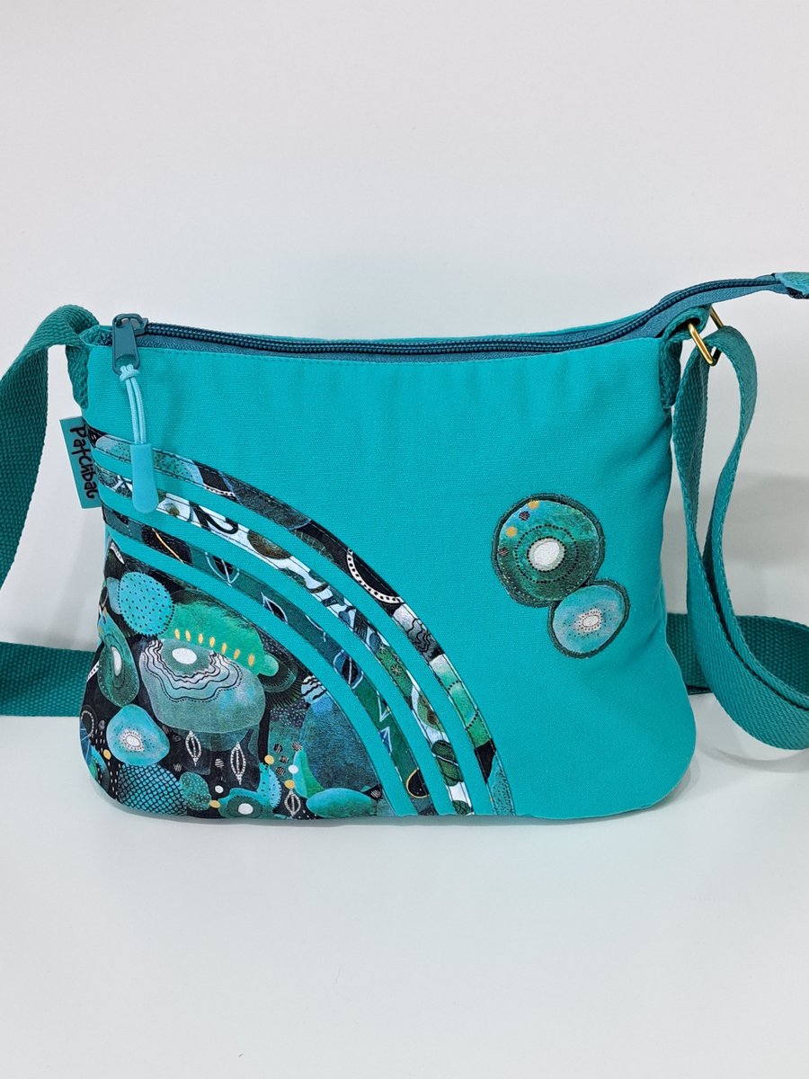 Small turquoise handbag with  green ornaments 