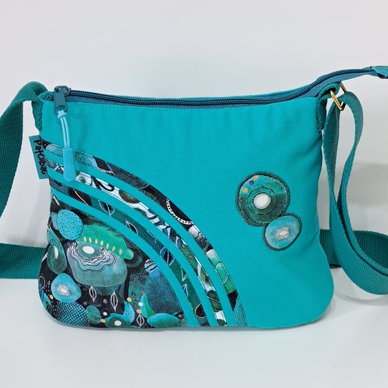 Small turquoise handbag with  green ornaments 