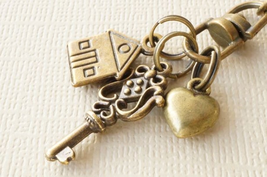 Antique bronze bag charm with key house and heart charms