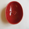 Half a red egg. Valentine ceramic dish