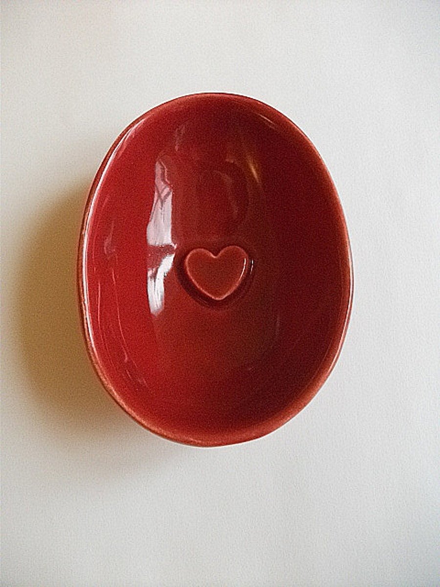 Half a red egg. Valentine ceramic dish