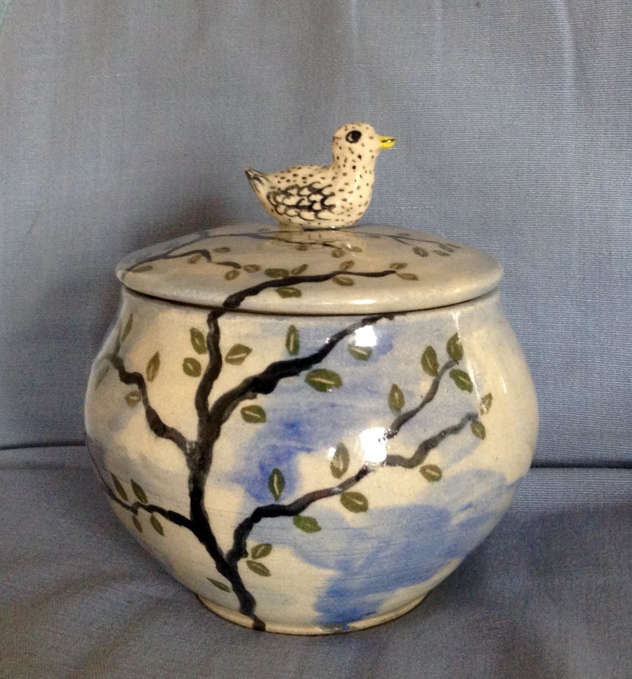  Storage jar in blue with tree, birds and clouds and bird lid. 