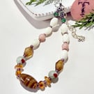 Delicate glass bead bracelet in neutral colours with extender chain.