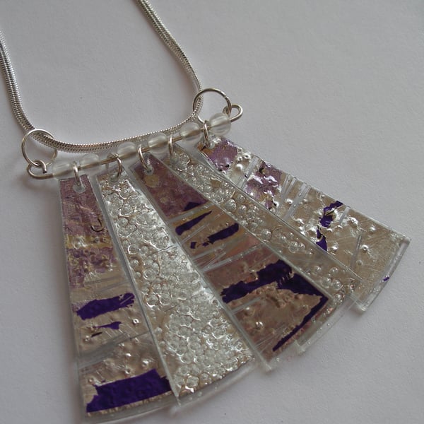 Silver and purple coloured pendant.