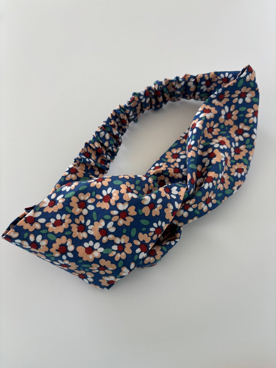 Cotton headband, twist knot style hairband in blue with a daisy floral print.