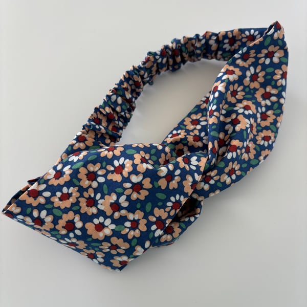 Cotton headband, twist knot style hairband in blue with a daisy floral print.