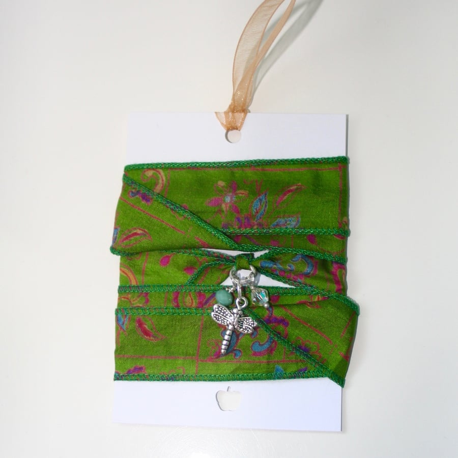 Green patterned silk ribbon wrap bracelet with dragonfly charm