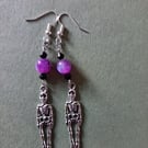 Silver skeleton dangle earrings with purple and black beads