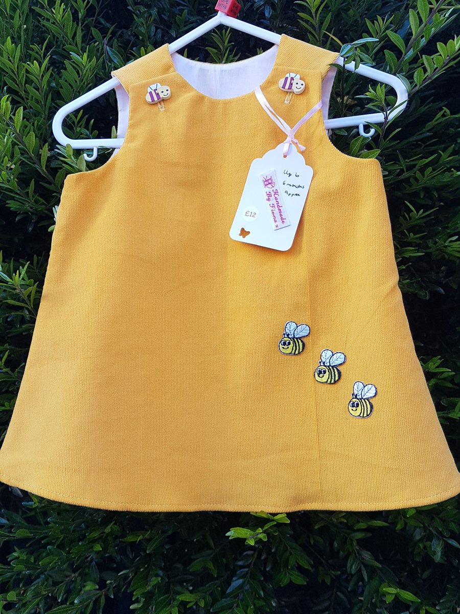 Age: 3-6m. Yellow needlecord pinafore dress. 