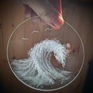 Wave with seagulls on a glass window disk 