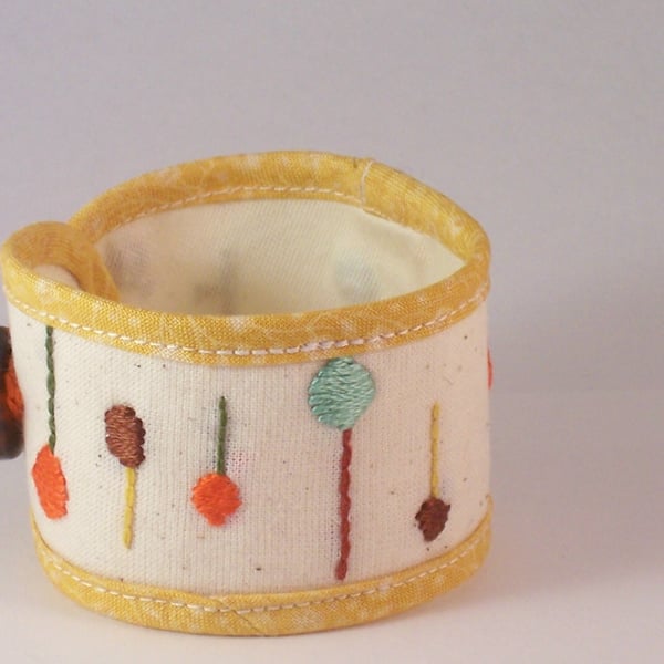 Hand embroidered textile cuff in summery yellow and cream - Lollipop tree 