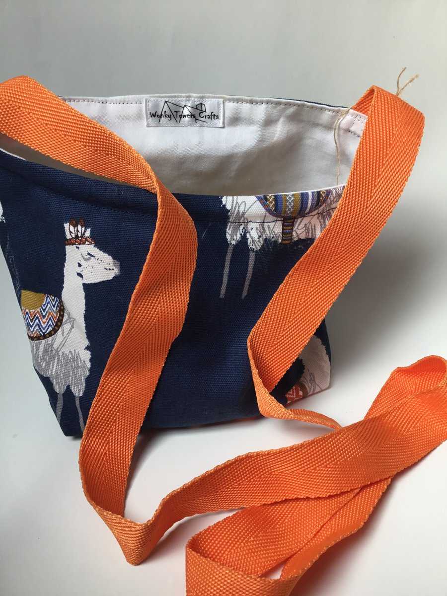 Peg bag, cross-body style. Blue alpaca fabric with orange strap.