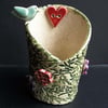 Tall ceramic tea light holder with bird, heart and flowers