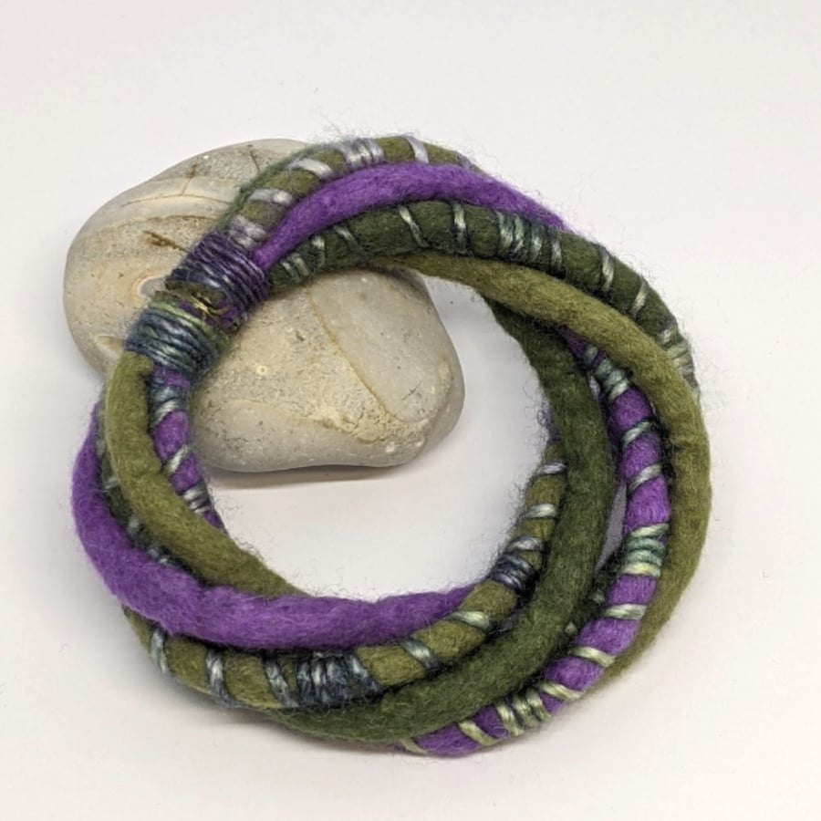 Felted cord bracelet in shades of purple and olives