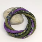 Felted cord bracelet in shades of purple and olives