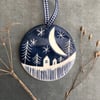 Ceramic Winter scene hanging decoration.