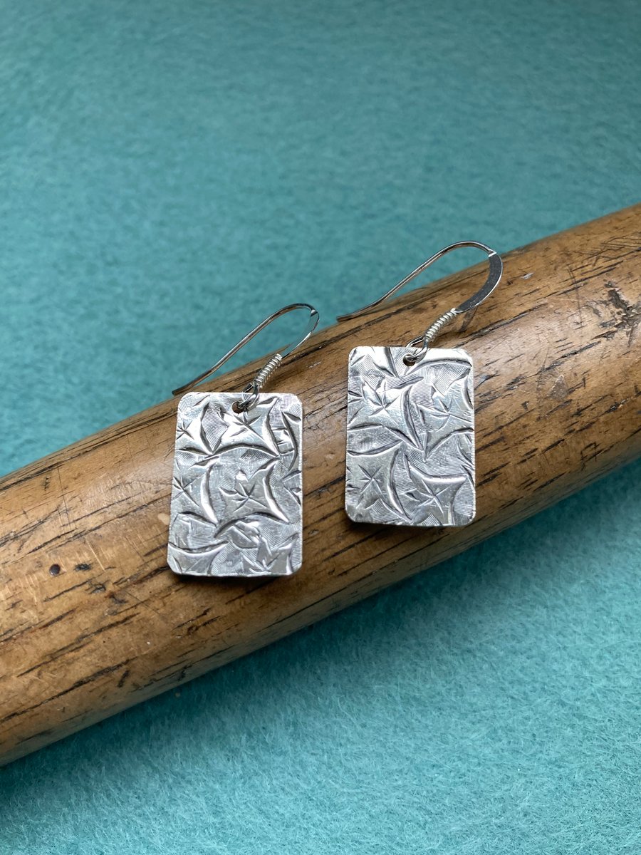 Silver earrings made from an 1899 Birmingham cigarette case