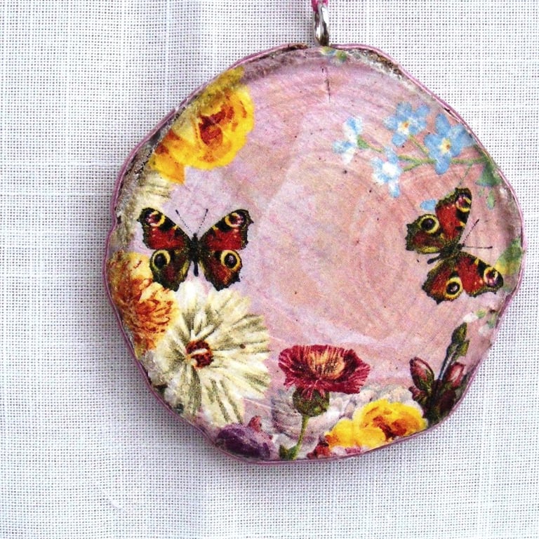 Peacock butterfly decoupaged log slice wall decoration.