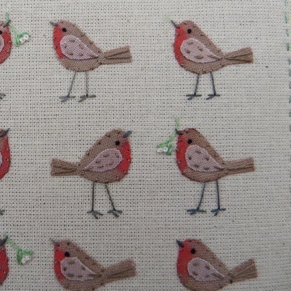 Small framed hand-stitched textile of robins with mistletoe