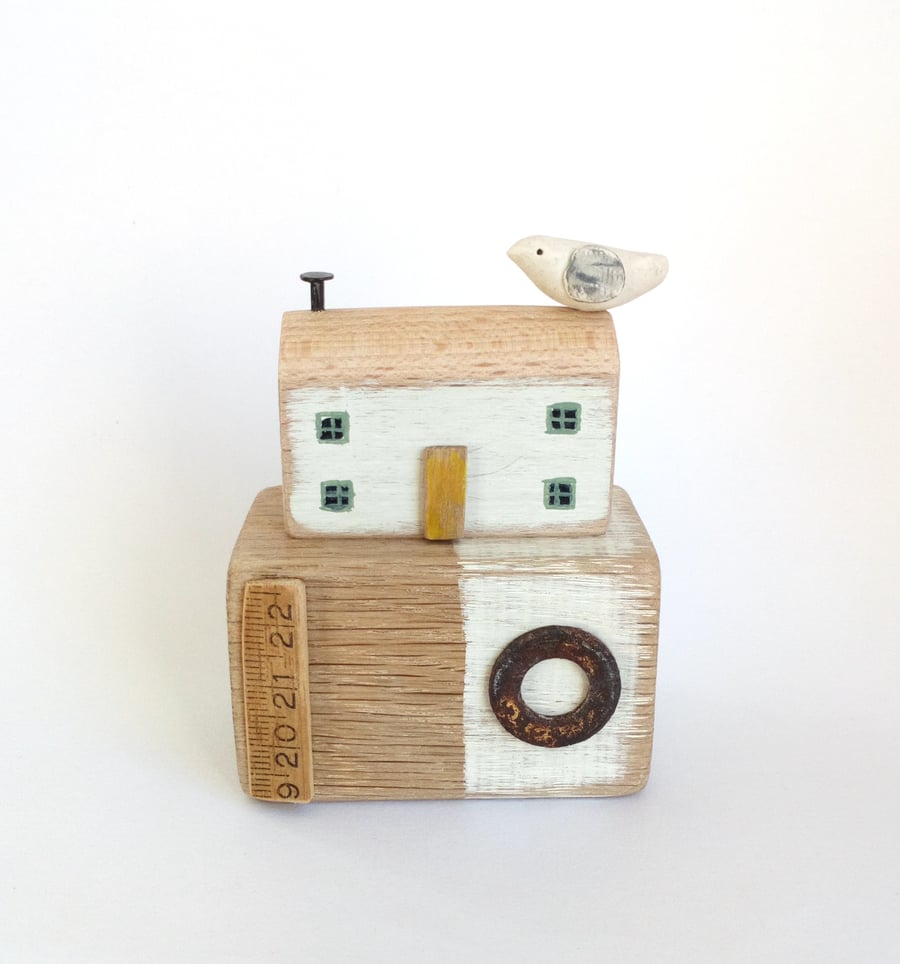 Little wooden seaside house with clay bird