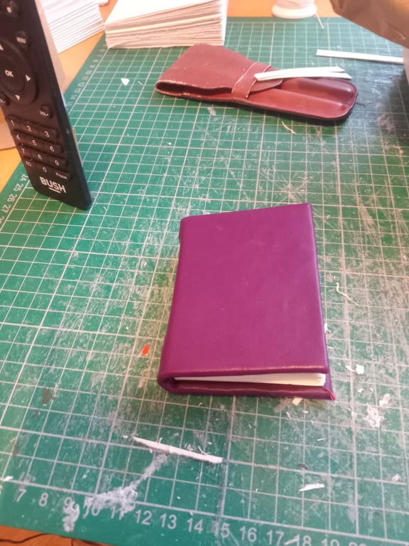 Mini notebook with purple leather cover imperfectly handmade with blank pages