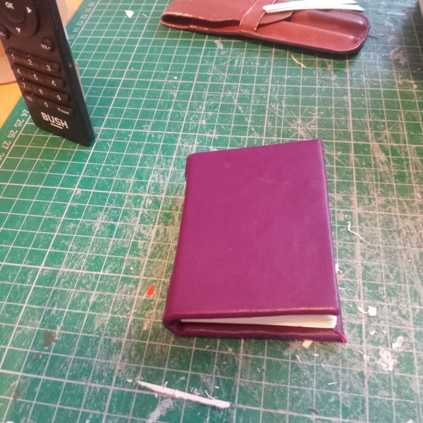 Mini notebook with purple leather cover imperfectly handmade with blank pages